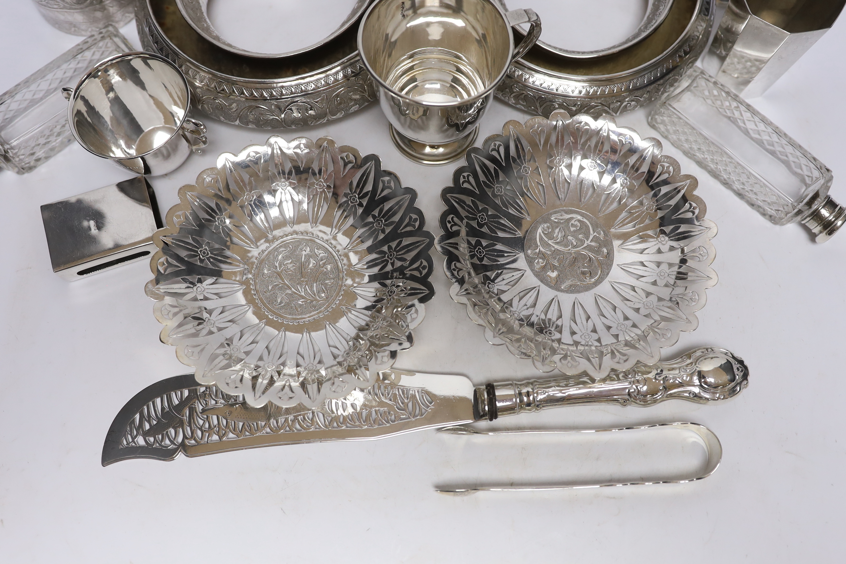 A group of silver and a white metal items including two Middle Eastern ring vases, two foliate dishes, a vase and a canister, together with a silver christening mug, 800 standard beaker, silver fish slice, two mounted gl